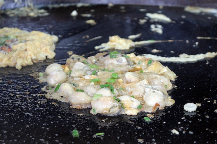 A hot wok and fresh plump oysters are essential to a good plate of orh luak.